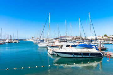Marina Rubicon Playa Blanca coastal vacation resort, famous yachting port and market place, with volcanic mountains in the background. Lanzarote, Canary Islands, Spain.