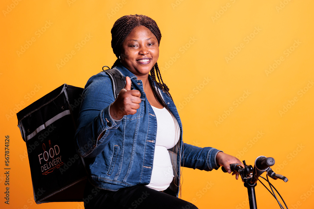 Wall mural successful delivery employee doing thumbs up sign while delivering takeaway meal to customers during