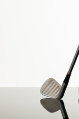Close up of golf club with copy space and reflection on white background