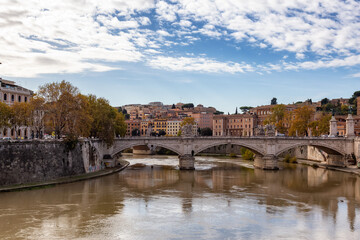 River Tiber and Bridge in a historic City, Rome, Italy. Sunny and Cloudy day.