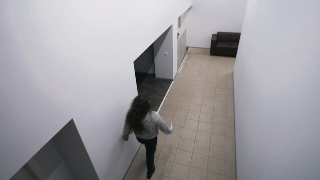 Female secretary goes to workplace. Colleagues meeting and greeting at corridor, discussing plans. Man in glasses comes to reception and takes work papers. Business center. Security camera shooting.