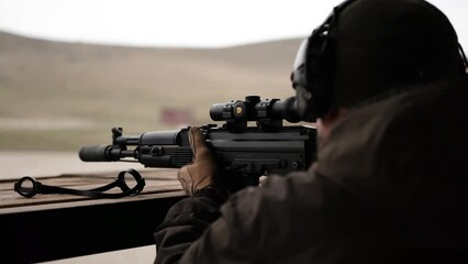 soldier shooting from a sniper and machine gun in military uniform shooting army - Powered by Adobe
