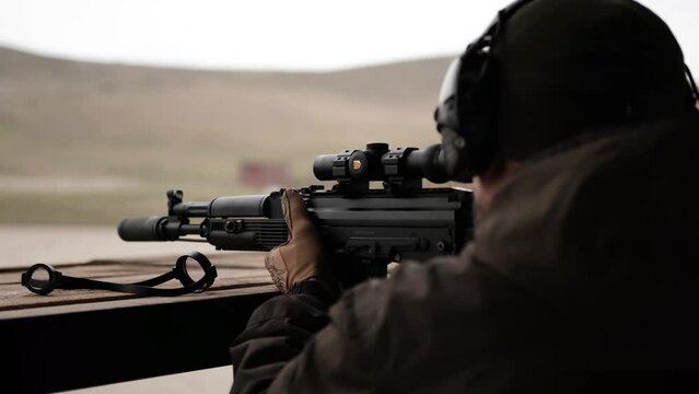 soldier shooting from a sniper and machine gun in military uniform shooting army
