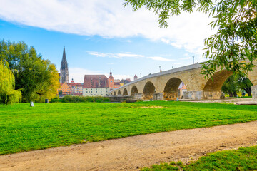 The old stone bridge over the Danube River with the Saint Peter Cathedral in view in the Bavarian city of Regensburg, Germany.	