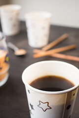 Coffee and coffee with milk in some disposable cups on a table in the office