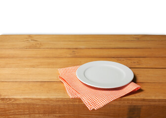 Empty wooden table with color tablecloth and plate