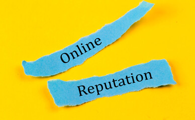 ONLINE REPUTATION text on a blue pieces of paper on yellow background, business concept