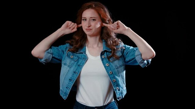 (Camera: ARRI ALEXA, 35mm lens, real time) A young caucasian woman plugs her ears. For more variations of this clip, check out this seller's other videos.