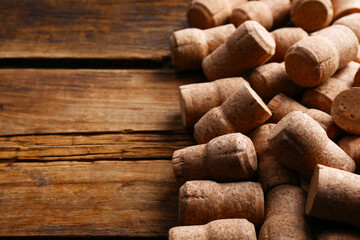Sparkling wine bottle corks on wooden table. Space for text