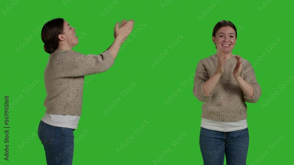 Wall mural Caucasian woman clapping hands and congratulating people in studio, being cheerful and happy. Young adult applauding and cheering, showing support with standing ovation gesture. - Wall murals
