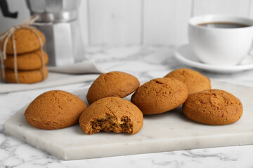 Tasty oatmeal cookies on white marble table