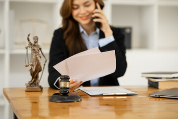 Female lawyer working at client's office discussing documents