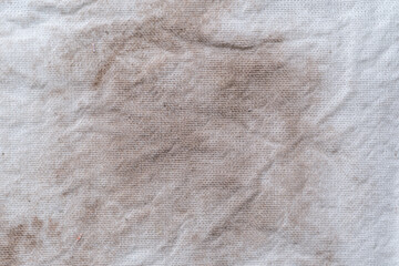 Detalle de textura de tela manta, manchada con polvo café cobrizo
