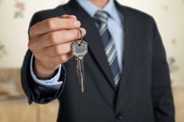 Person holding keys, real estate