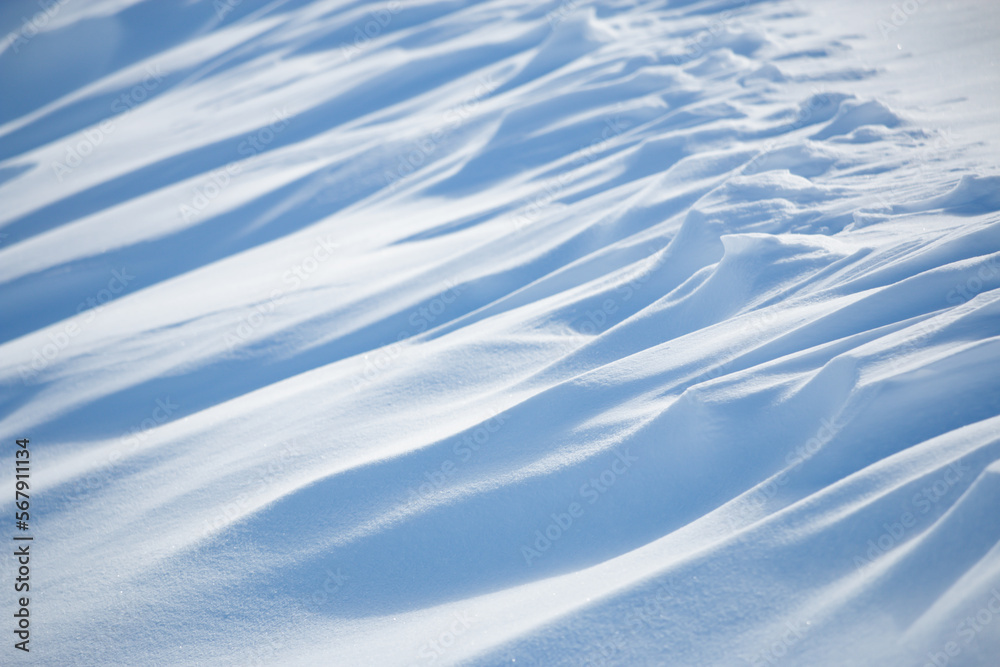 Wall mural abstract shadow and light patterns in winter snow landscape background