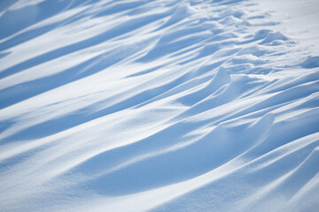 Abstract shadow and light patterns in winter snow landscape background
