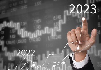 Young smart business man worker with 2023 graph