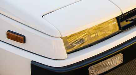 Close-up of a car headlight on a white background