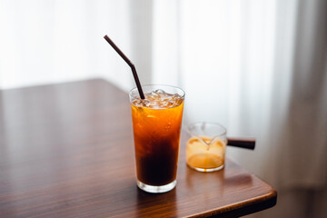 Iced black coffee on desk at home