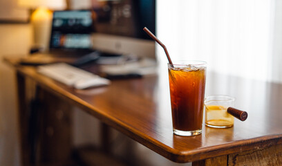 Iced black coffee on desk at home