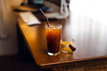 Iced black coffee on desk at home