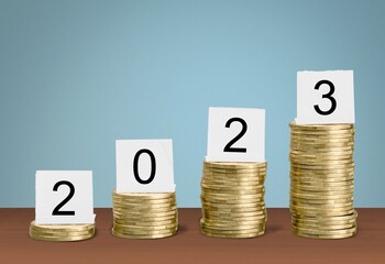 Stack of golden coins with 2023 numbers