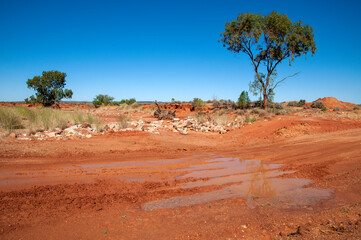 White Cliffs Australia, water damage to red dirt road 