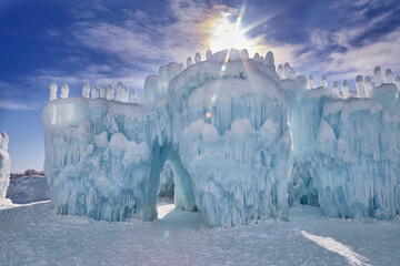 Sun rising over a snow covered winter ice fort on a cold day in Minnesota USA