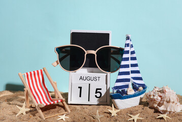 Beach holiday composition with sand, seashells, , sunglasses, sailboat, deck chair and wooden block...