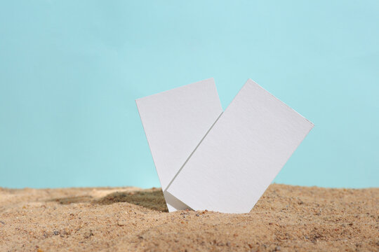 Corporate Identification For A Travel Company. White Empty Business Cards In The Sand