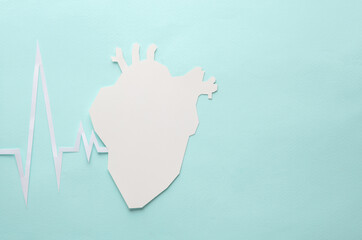 Paper-cut heart with cardiogram rhythm on a blue background. Healthy heart concept. Creative medicine layout