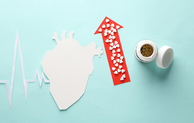 Paper-cut heart with a cardiogram rhythm, up arrow and pills on a blue background. Healthy heart...