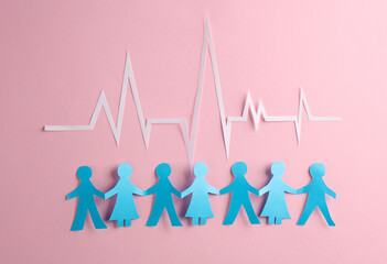 People Chain with a cardiological heart rhythm cut out of paper on pink background. Nation health - obrazy, fototapety, plakaty