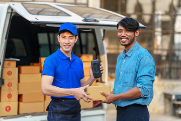 Delivery man asia people checking portable delivery device with parcel box to customer home address. give delivery box to customer and sign a signature of receiver people © M+Isolation+Photo