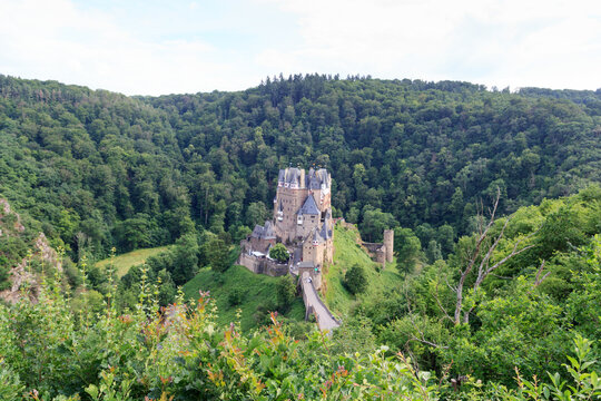 Wierschem, Germany - June 26, 2021: Panoroma with medieval Eltz Castle in the hills above the Moselle. It is still owned by a branch of House of Eltz who have lived there since the 12th century.