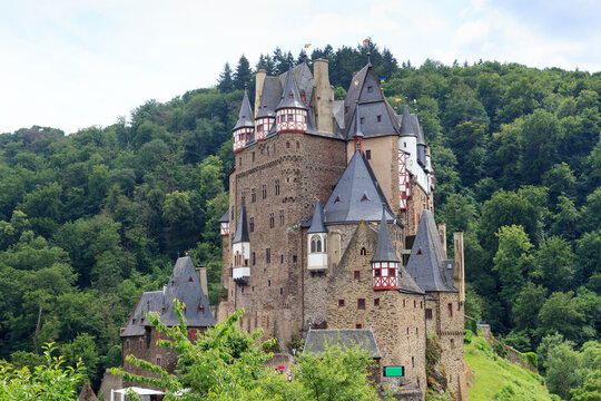 Wierschem, Germany - June 26, 2021: Panoroma with medieval Eltz Castle in the hills above the Moselle. It is still owned by a branch of House of Eltz who have lived there since the 12th century.