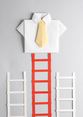 Origami shirt at the top of the stairs. Leadership, career growth, business concept
