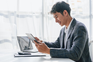 Portrait of bookkeepers asia business man working on tax consultant law in a modern office. Make an...