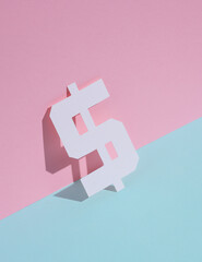 Paper-cut dollar symbol on blue-pink pastel background