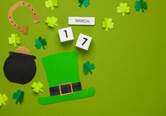 St.Patrick 's Day. Calendar with date march 17 with holiday themed handmade decor on green background. flat lay. Top view