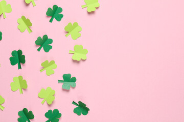 St.Patrick 's Day. Paper-cut clover leaves on pink background. March 17. Paper art. Flat lay. Copy...