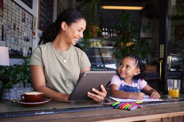 Black family, children and remote work in a coffee shop with a mother and daughter sitting together...