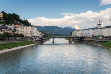 Obraz premium Views of the river Salzach from the Marko-Feingold-Steg bridge, Salzburg, Austria. It can be seen the city hall clock tower and the Staatsbrücke bridge