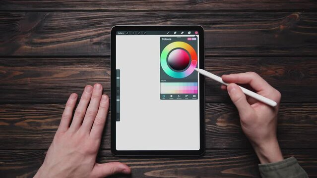 man works with a color palette on a graphic tablet.