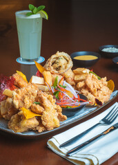 Photographs of chicharron de pescado on the table of a typical fish and seafood restaurant.