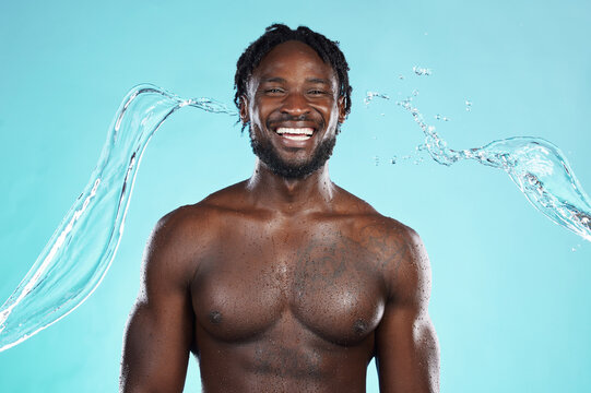 Water Splash, Portrait And Black Man Isolated On Blue Background For Face Cleaning, Body Shower And Skincare. Strong, Beauty And Happy Model Or Person Muscle With Studio Headshot, Washing Or Hygiene