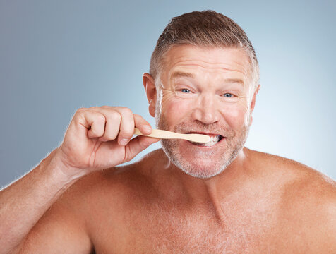 Portrait, Mouth Or Old Man Brushing Teeth With Dental Toothpaste For Healthy Oral Hygiene Grooming In Studio. Eco Friendly, Funny Or Senior Person Cleaning With A Natural Bamboo Wood Toothbrush