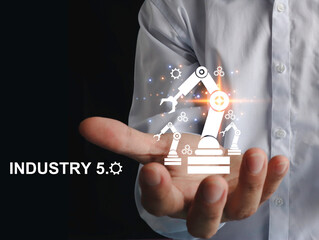 Engineer's hand showing automation robotic arm icon. augmented reality machine simulation in smart factory industry Industry 5.0 concept