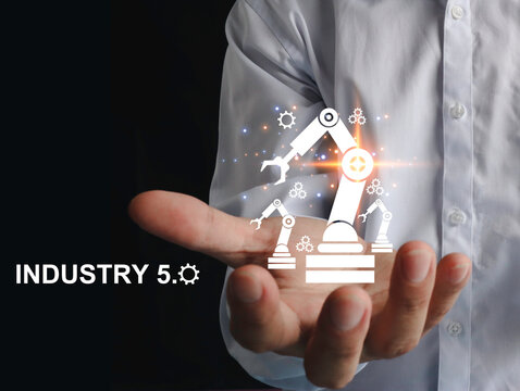 Engineer's hand showing automation robotic arm icon. augmented reality machine simulation in smart factory industry Industry 5.0 concept