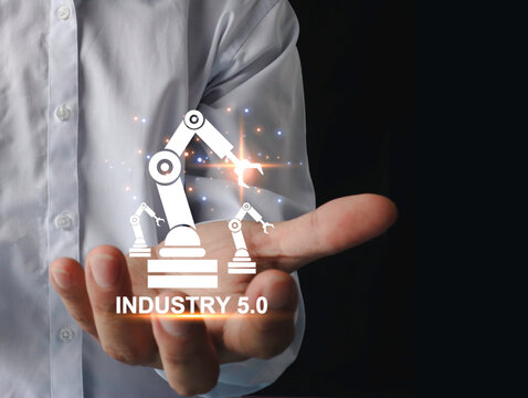 Engineer's hand showing automation robotic arm icon. augmented reality machine simulation in smart factory industry Industry 5.0 concept